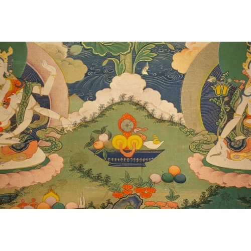 99 - A Tibetan Thangka of Amitayus, early 20th century, seated within a gilt sunburst halo, with deities,... 