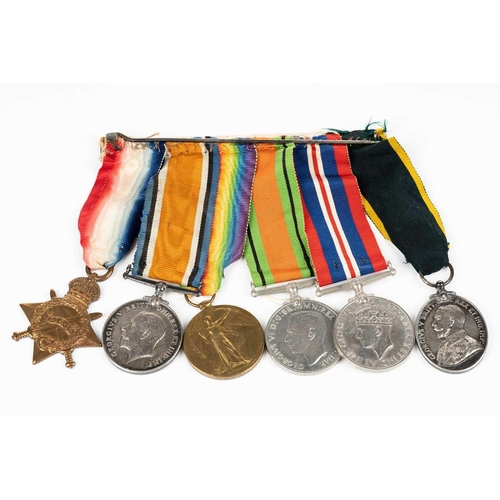 204 - A WWI and WWII medal group, comprising a 1914-15 Star, a WW1 Campaign and a Victory medal, each name... 