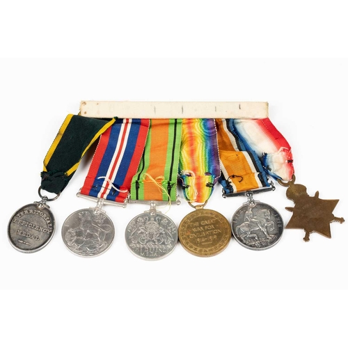 204 - A WWI and WWII medal group, comprising a 1914-15 Star, a WW1 Campaign and a Victory medal, each name... 