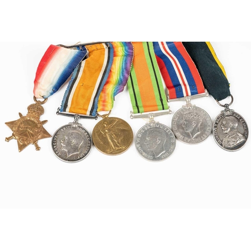 204 - A WWI and WWII medal group, comprising a 1914-15 Star, a WW1 Campaign and a Victory medal, each name... 