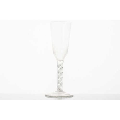 212 - An 18th century ale glass, the long bowl with crossed barley corns, on a plain stem and folded foot,... 