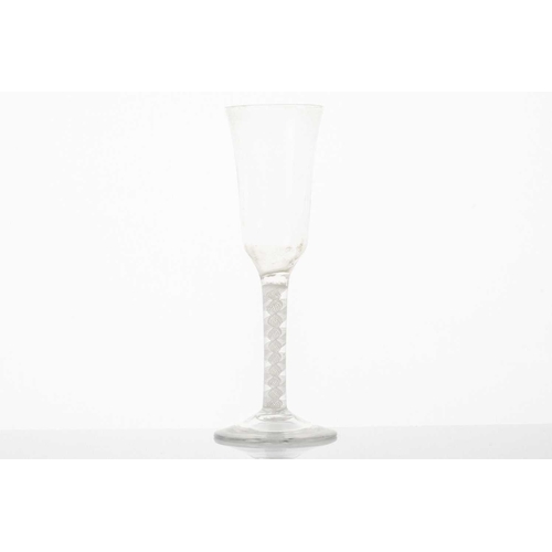 212 - An 18th century ale glass, the long bowl with crossed barley corns, on a plain stem and folded foot,... 