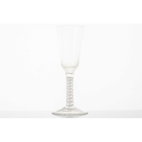 215 - An 18th century ale glass, the ogee bowl on a multiple opaque air twist stem and conical circular fo... 