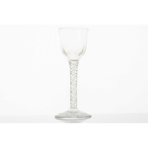 215 - An 18th century ale glass, the ogee bowl on a multiple opaque air twist stem and conical circular fo... 