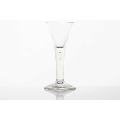 215 - An 18th century ale glass, the ogee bowl on a multiple opaque air twist stem and conical circular fo... 