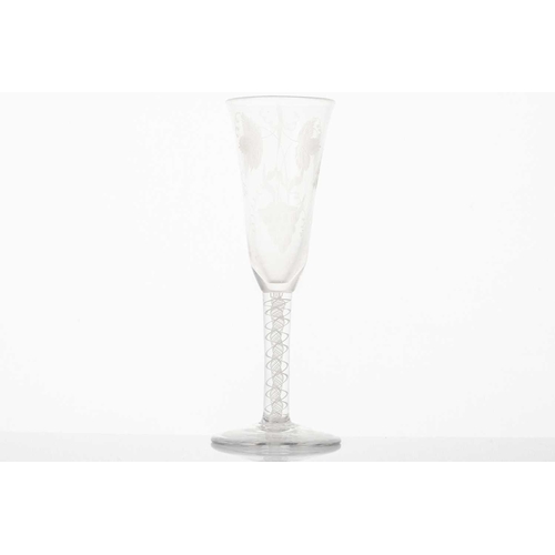 217 - A late 18th century wine glass, the trumpet form bowl with hops and barley, on a plain stem and fold... 