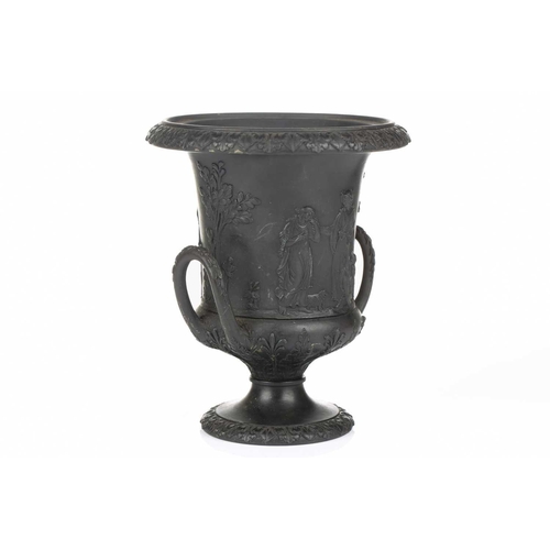 221 - A 19th century Wedgwood black basalt urn of Campagna form, relief decorated with neo-classical figur... 