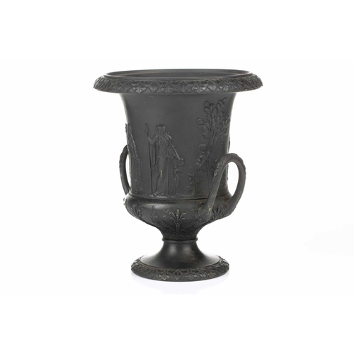 221 - A 19th century Wedgwood black basalt urn of Campagna form, relief decorated with neo-classical figur... 