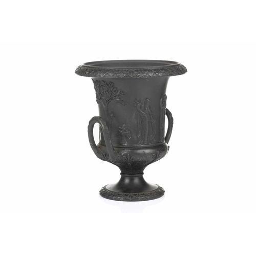 221 - A 19th century Wedgwood black basalt urn of Campagna form, relief decorated with neo-classical figur... 