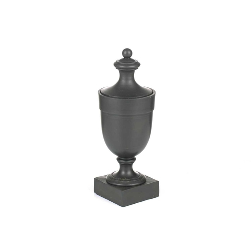 227 - Wedgwood & Bentley, Etruria: a late 18th century black basalt urn and cover, of plain form on a squa... 