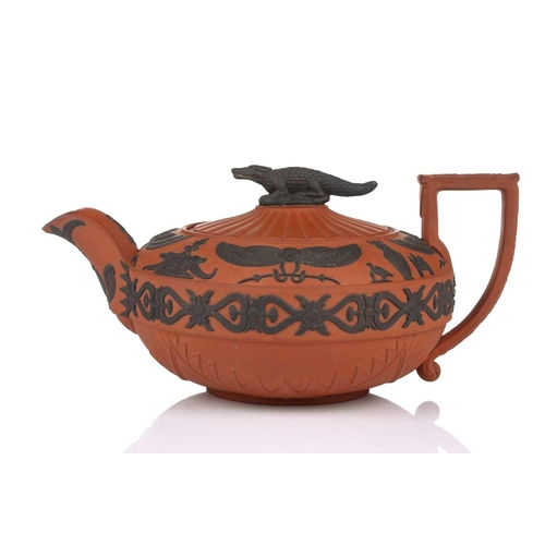 232 - A Wedgwood rosso antico teapot and cover, early 19th century, with applied Egyptian decoration, the ... 