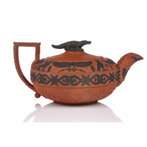 232 - A Wedgwood rosso antico teapot and cover, early 19th century, with applied Egyptian decoration, the ... 