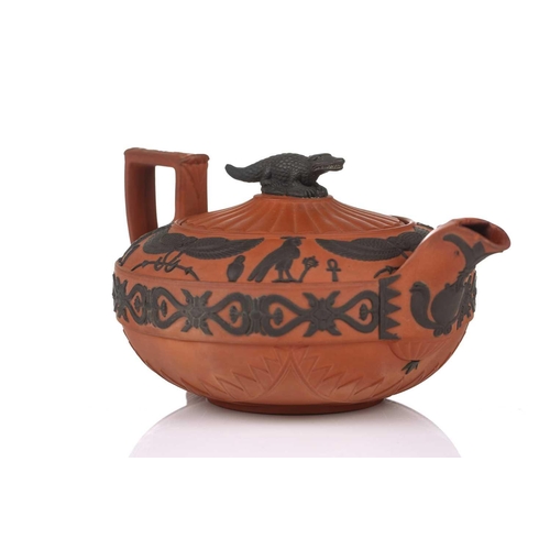 232 - A Wedgwood rosso antico teapot and cover, early 19th century, with applied Egyptian decoration, the ... 