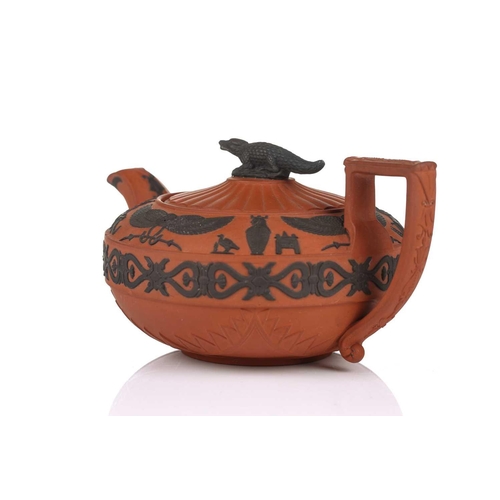 232 - A Wedgwood rosso antico teapot and cover, early 19th century, with applied Egyptian decoration, the ... 