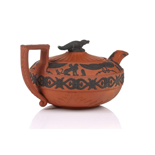 232 - A Wedgwood rosso antico teapot and cover, early 19th century, with applied Egyptian decoration, the ... 