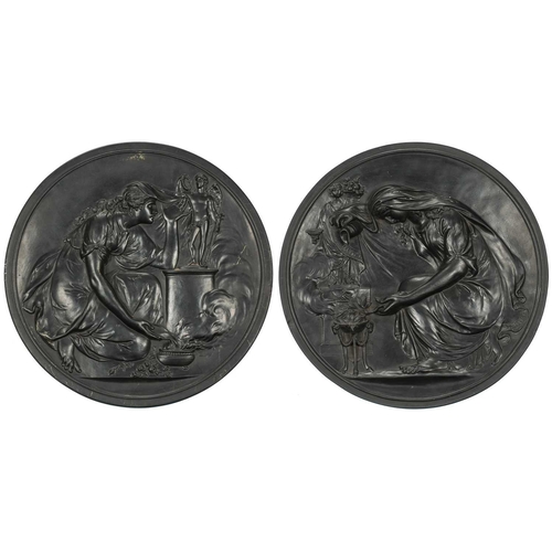 238 - A pair of large late 19th century Wedgwood black basalt circular plaques, depicting neo-classical fi... 