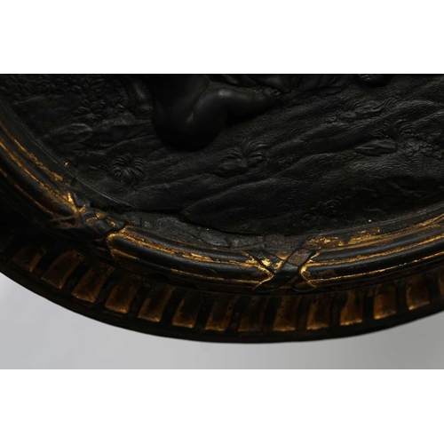 243 - A late 18th-century black basalt oval plaque, probably by Wedgwood and Bentley (unmarked), depicting... 