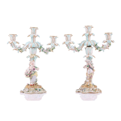 244 - A pair of German porcelain figural three sconce candelabra, with tre stum stems mounted with a brigh... 