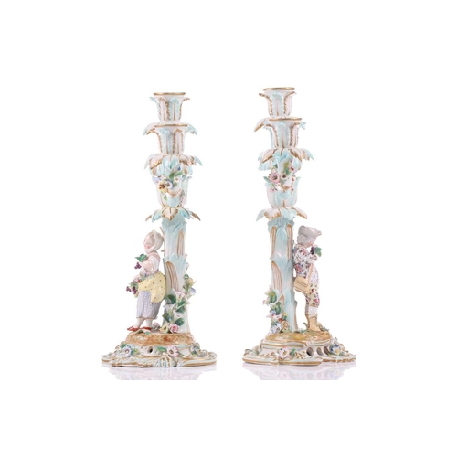 244 - A pair of German porcelain figural three sconce candelabra, with tre stum stems mounted with a brigh... 