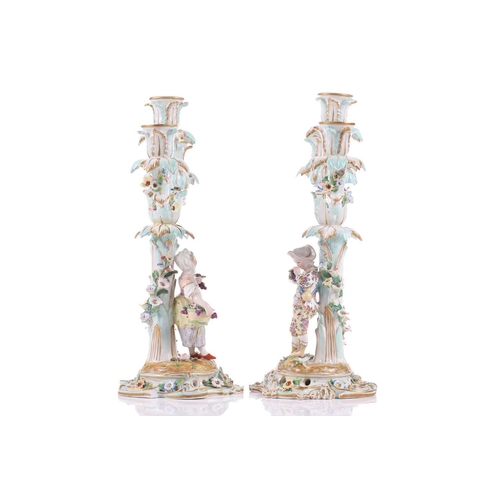 244 - A pair of German porcelain figural three sconce candelabra, with tre stum stems mounted with a brigh... 