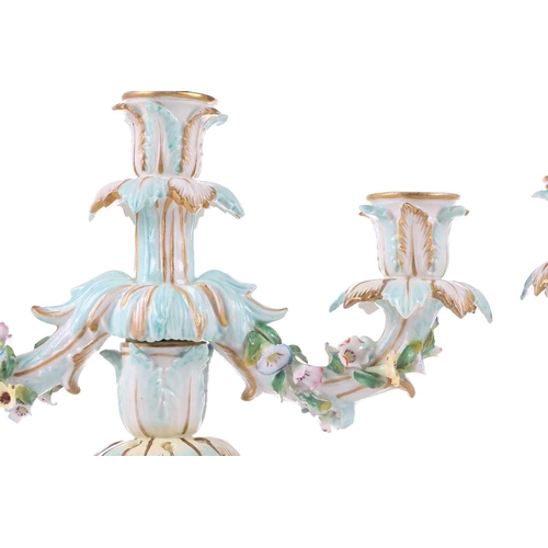 244 - A pair of German porcelain figural three sconce candelabra, with tre stum stems mounted with a brigh... 