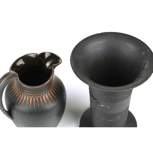 245 - An early 19th century Wedgwood black basalt vase, of flared rim form with twin satyr mask decoration... 