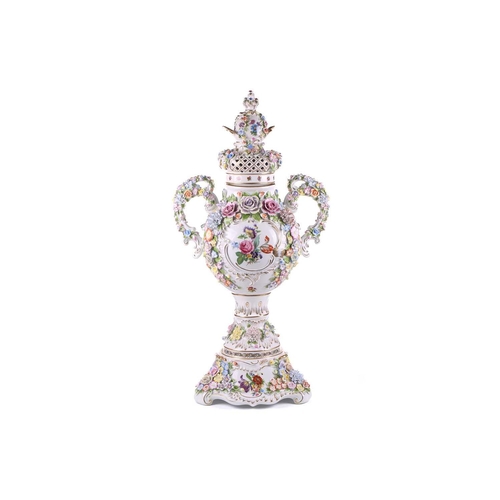 246 - A large German porcelain flower encrusted two handled trophy form urn and cover, 20th century, with ... 