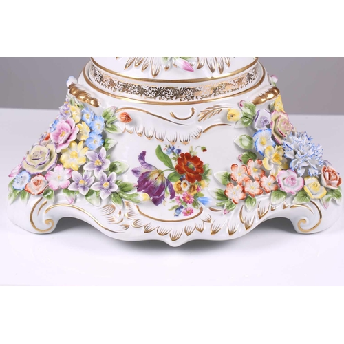 246 - A large German porcelain flower encrusted two handled trophy form urn and cover, 20th century, with ... 