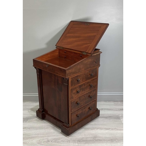 115A - An early Victorian mahogany Davenport desk with a sliding leather inset and fitted top section above... 