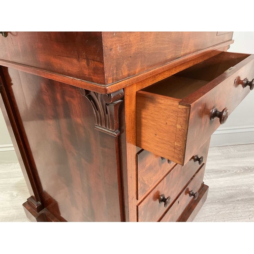 115A - An early Victorian mahogany Davenport desk with a sliding leather inset and fitted top section above... 