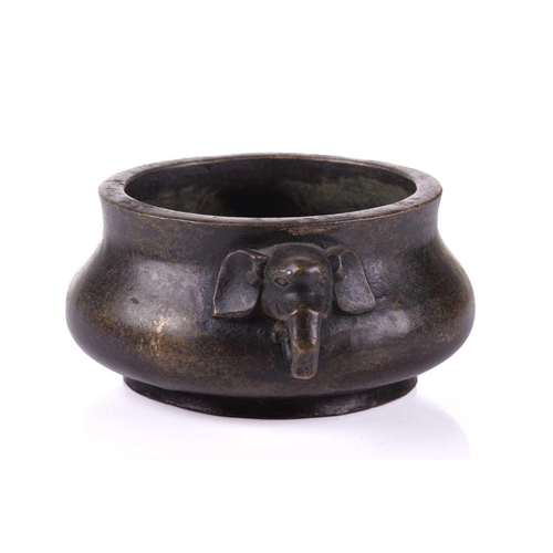 128 - A Chinese bronze censer, with thick walled compressed body, with applied elephant mask handles, apoc... 