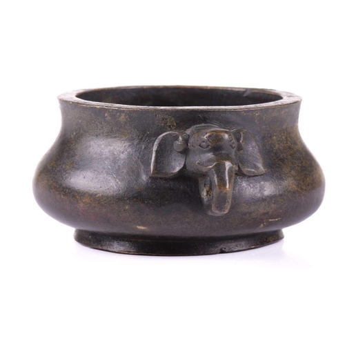 128 - A Chinese bronze censer, with thick walled compressed body, with applied elephant mask handles, apoc... 