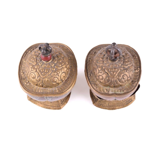 134 - A close pair of Tibetan kapala and stands, early 20th century, each with cast vajra knop above an em... 