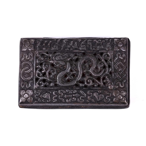 135 - A Tibetan white metal rectanguler box, the pierced top with a dragon amongst clouds with a border of... 