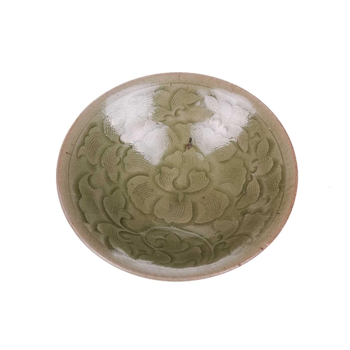 138 - A Chinese Longquan celadon bowl, the interior with lotus flower and petal decoration, on a short cir... 