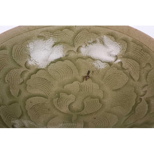 138 - A Chinese Longquan celadon bowl, the interior with lotus flower and petal decoration, on a short cir... 