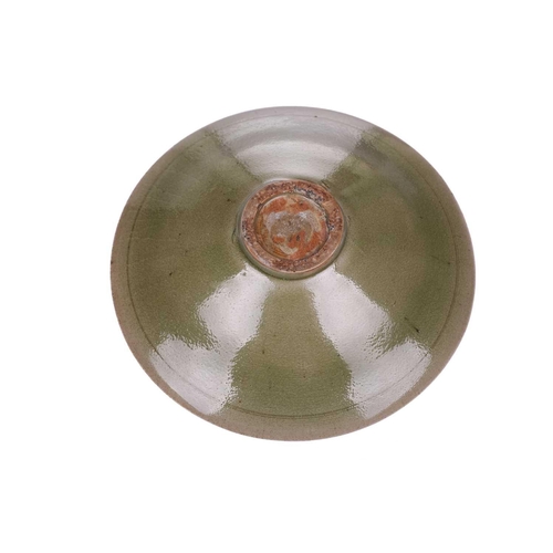 138 - A Chinese Longquan celadon bowl, the interior with lotus flower and petal decoration, on a short cir... 