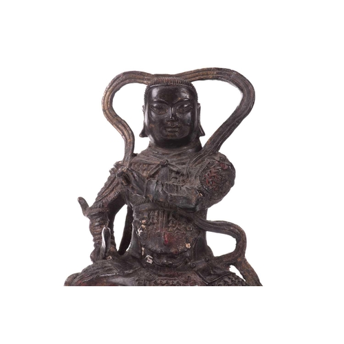 157 - A Chinese bronze figure of Zhenwu, seated wearing body armour and a sword in his left hand, a tortoi... 