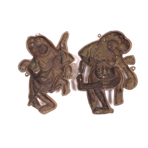 158 - A pair of embossed and gilded copper Buddhist temple appliques, modelled as wrathful deities, each m... 