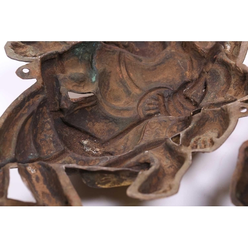 158 - A pair of embossed and gilded copper Buddhist temple appliques, modelled as wrathful deities, each m... 