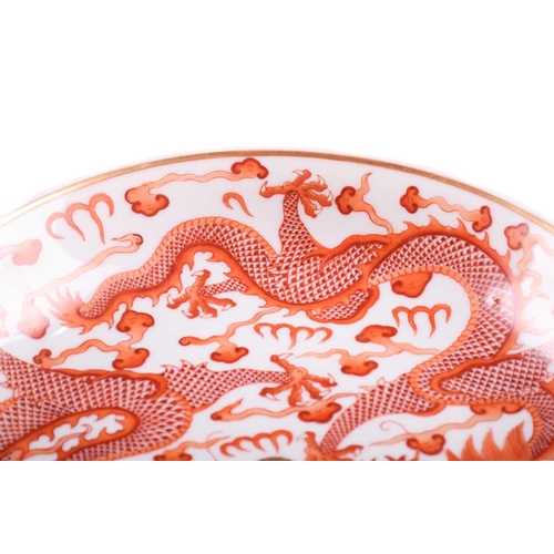 159 - A Chinese porcelain iron red dragon dish, painted with two opposing dragons with turquoise eyes and ... 