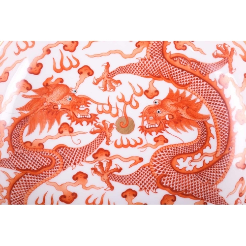 159 - A Chinese porcelain iron red dragon dish, painted with two opposing dragons with turquoise eyes and ... 