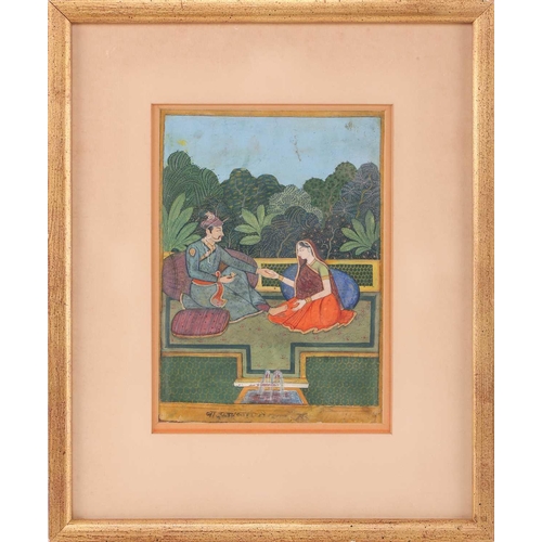 169 - 19th century Indian School, Shah and consort, seated on cushions within a fenced garden, a small fou... 