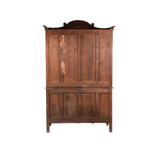 171 - A 19th Century Normandy pine kitchen buffet cupboard, with arched cresting above a pair of shaped an... 