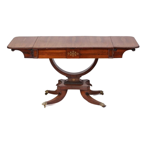 173 - A Regency brass inlaid figured rosewood two-flap sofa table with split bobbin moulded edge above a p... 