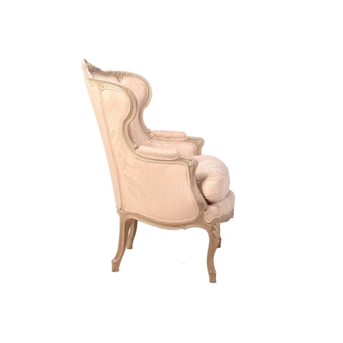 203 - A French Louis XV-style dove grey painted bergere armchair with wing back and carved shell cresting ... 