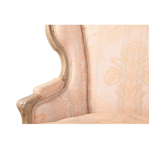 203 - A French Louis XV-style dove grey painted bergere armchair with wing back and carved shell cresting ... 