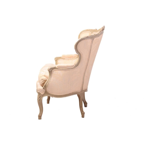 203 - A French Louis XV-style dove grey painted bergere armchair with wing back and carved shell cresting ... 