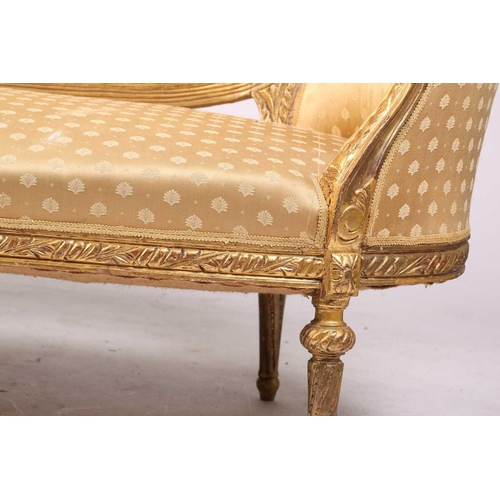 206 - A Louis XVI style carved and giltwood three-seat canape/ sofa, 20th century, with rose-carved cresti... 