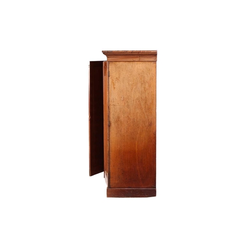 234 - An early Victorian mahogany housekeeper's cupboard, the pair of doors with arched panels opening to ... 